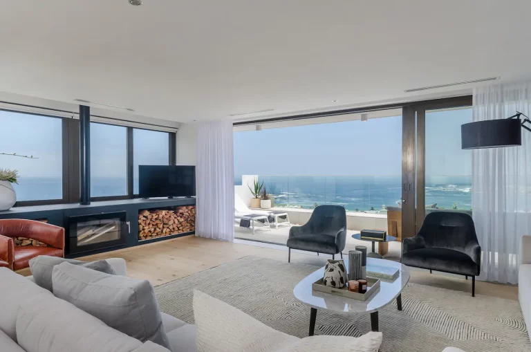 Living Room (A) with Indoor Fireplace- Cosy fires and spectacular sunset views from the lounge area